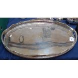 A silver plate on copper oval tea tray, with pierced gallery