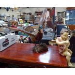 An Antique painted wood cherub, height 11", and a painted wood figure of a duck