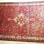 A Persian red ground Hamedan rug, 292cm x 157cm