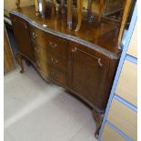 A burr-walnut serpentine-front reproduction sideboard, with fitted drawers and cupboards, on