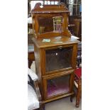 A late Victorian mahogany music cabinet, with raised mirror-back and etched glass panel doors, W56cm