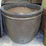 A large lustre glazed terracotta garden plant pot, W62cm