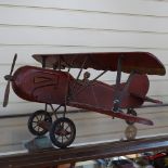 A painted wood replica biplane with iron struts, wingspan 29"