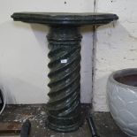 A spiral turned marble pedestal