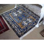 A cream and blue ground Beluchi rug, 120cm x 106cm