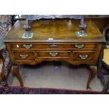 A cross-banded walnut lowboy with 4 fitted drawers, on cabriole legs, W91cm