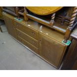 An Ercol sideboard, fitted drawers and cupboards, L157cm