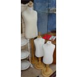 A set of 3 modern mannequins on wooden stands, tallest 54"