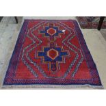 A red ground Beluchi rug, 135cm x 92cm