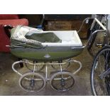 A green and white Silver Cross doll's pram