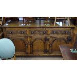 An Ipswich oak design dresser base, with 3 frieze drawers, with fielded panelled cupboards under, on