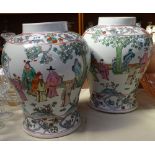A pair of Chinese vases decorated with figures, 13.5"