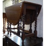 An oak oval gateleg table with barley twist legs, W87cm