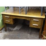 A 1930s oak 5-drawer writing desk, W136cm