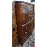 An early 19th century mahogany 2-section linen press, panelled doors revealing 2 fitted slides, with