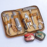 A leather-cased silver plated miniature toolset, and 2 tins of gramophone needles