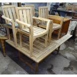 A large slatted teak extending garden table, together with a set of 4 matching teak elbow chairs,