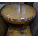 A 1930s walnut circular coffee table