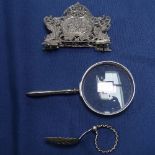 A Swedish silver letter rack, a Norwegian finger spoon, and a silver-handle magnifying glass