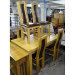 A modern oak draw leaf dining table, together with a set of matching oak and leather dining chairs