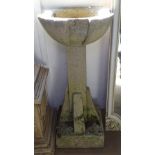 A weathered concrete garden bird bath, H85cm