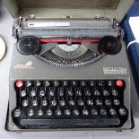 A Vintage Baby Empire Deluxe portable typewriter, with metal case