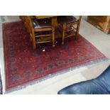 A large red ground wool Persian design carpet, 220cm x 177cm