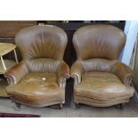 A pair of modern brown leather upholstered armchairs, on turned mahogany legs