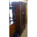 A 1920s carved and panelled oak single door hall cupboard, W91cm