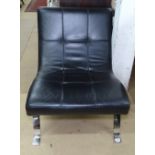 A black leather and flat bar steel chrome lounge chair