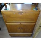 An Ercol bureau cabinet, with fall-front, and cupboard doors under, W82cm