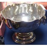 A silver plate on copper punch bowl, with shaped top and lion mask ring handles