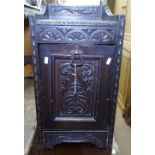 A Victorian carved oak coal purdonium, W33cm