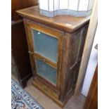 A hardwood side cabinet with single glazed door and drawer under, W59cm, H104cm
