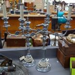 A pair of moulded and polished metal candelabra design twin-branch table lamps, height 21.5" overall