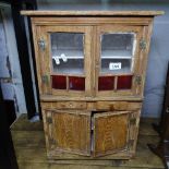 A stained pine table-top cabinet, with glazed and panelled doors, W40cm, H57cm