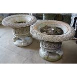 A pair of large weathered stoneware garden urns on stand, with lattice-weave decoration, W78cm,