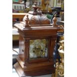 Carved oak-cased 2-train mantel clock, 18.5"