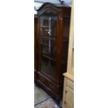 A hardwood arch-top display cabinet, with single glazed door, and drawers to the base, W76cm, H190cm