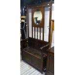 An Edwardian oak mirror-back hall stand