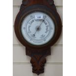 A carved oak-cased aneroid barometer, height 28"