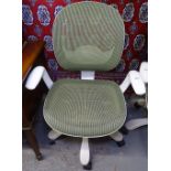 A white designer office chair with green mesh seat and back, fully adjustable