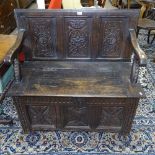 An Antique panelled oak hall bench, with rising seat and chip carved panels, on stile legs, W105cm