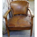 A 1920s oak and studded leather upholstered Club chair