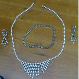 A matching silver and stone-set garniture of jewellery, necklace, bracelet, and a pair of clip-on