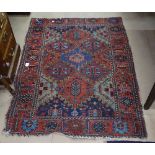 An Antique red ground Persian rug, 150cm x 115cm