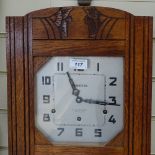 A Continental carved oak-cased wall clock, height 26"
