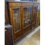 A French mahogany and satinwood-banded display cabinet, with 3 glazed and panelled doors, adjustable