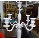 A white painted metal 4-branch floor standing candelabra