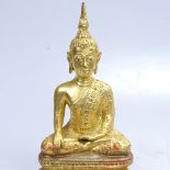 A painted and gilded bronze Buddha, 7.25"